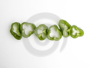Aerial view of a row of slices cut from a green pepper photo
