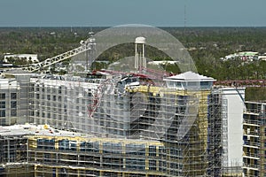 Aerial view of ruined by hurricane Ian construction crane on high apartment building site in Port Charlotte, USA photo