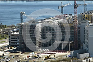 Aerial view of ruined by hurricane Ian construction crane on high apartment building site in Port Charlotte, USA photo