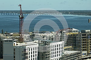 Aerial view of ruined by hurricane Ian construction crane on high apartment building site in Port Charlotte, USA photo