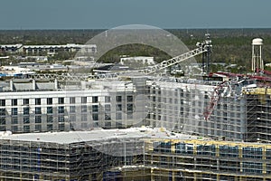 Aerial view of ruined by hurricane Ian construction crane on high apartment building site in Port Charlotte, USA photo