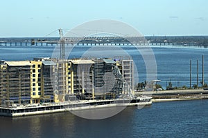 Aerial view of ruined by hurricane Ian construction scaffolding on high apartment building site in Port Charlotte, USA photo