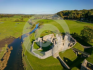 Aerial view of a ruined Norman era castle in a rural area Ogmore Castle, Wales