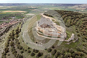 A prominent castle in ruins up on the hill - Castrojeriz, Castile and Leon, Spain photo