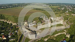 Aerial view of the ruins of a large medieval castle in Europe.