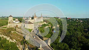 Aerial view of the ruins of a large medieval castle in Europe.