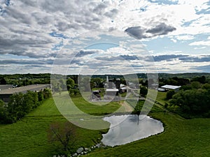 Aerial view of rural agricultural landscape with multiple farm buildings, Rogers Farm Haverhill, Ma