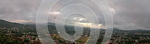 Aerial view of rural Blantyre, Malawi. It is a cloudy day with the residential neighborhood in the foreground and the mountain in