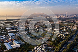 Aerial View of rural green fields in Hong Kong border and skylines in Shenzhen