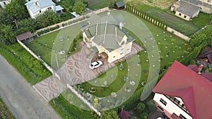 Aerial view of rural residential area with private homes between green fields.