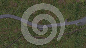 Aerial view of a rural road and cars driving on it