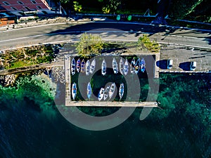 Aerial view of rural road by the sea with fishing boats in Italy