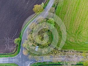 Aerial view of a rural road with trees, grassland and arable land in Drenthe, the Netherlands