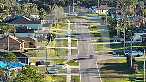 Aerial view of rural street traffic with driving cars in small town. American suburban landscape with private homes in