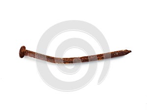 Aerial view of rusty nail on white background. Close up of old wry rusty nail shot from above on white. Hardware store object