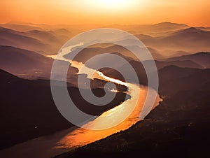 aerial view of s shaped bend river over layered mountains