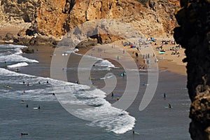 Aerial view from the Sagres Cape to the Tonel Beach during summer with a lot of tiny surfers Algarve.