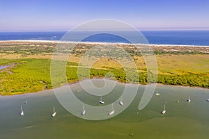 Aerial view of sailboats on river next to ocean in Saint Augustine