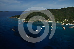 Aerial view of Sailing boats from above over a blue water