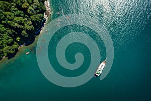 Aerial view of a sailing yacht in the turquoise sea