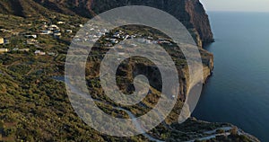 Aerial view of Salina coast, deep cliff, little village in a summer sunset. Blue sea, sky and wind for a peaceful moment