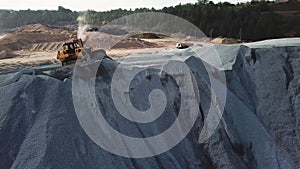 Aerial view of sand mining site conveyor with professional equipment at work. Stock footage. Flying above stone quarry
