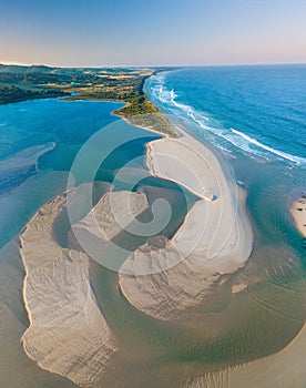 Aerial view of sand patterns in the shallow waters of the ocean inlet