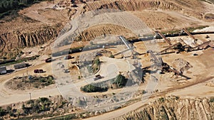 Aerial view sand quarry, industrial extraction of sand for construction industry. Drone flies over excavators and