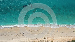 Aerial view of a sandy beach with crystal clear water