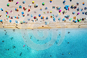 Aerial view of sandy beach with umbrellas and sea