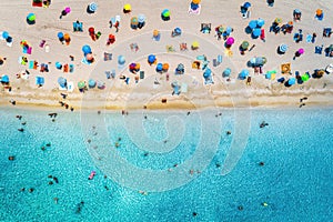 Aerial view of sandy beach with umbrellas and sea photo