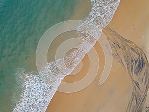 Aerial view sandy beach and waves Beautiful tropical sea in the morning summer season image by Aerial view drone shot High angle