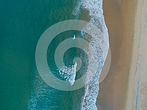 Aerial view sandy beach and waves Beautiful tropical sea in the morning summer season image by Aerial view drone shot High angle