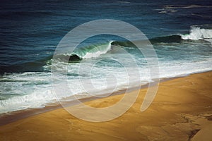 Aerial view of sandy North beach and Atlantc Ocean with big waves in Nazare, Portugal