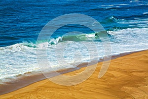 Aerial view of sandy North beach and Atlantc Ocean with big waves in Nazare, Portugal