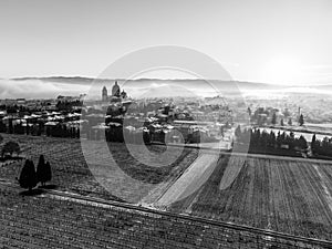 Aerial view of Santa Maria degli Angeli town and church at sunset, with meadows covered by snow