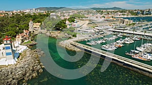 Aerial view of Santa Marta lighthouse and Cascais marina with Cascais cityscape