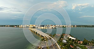 Aerial view of Sarasota city downtown with Ringling Bridge and high-rise office buildings on horizon. Real estate