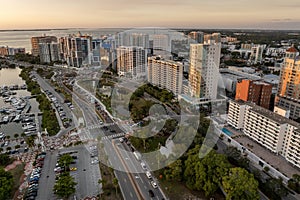 Aerial view of Sarasota city downtown at sunset with high-rise office buildings and Ringling Bridge on horizon. Real