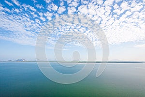 Aerial view, scenic landscape of coastline and mangrove forest in morning light. Beautiful clouds with light blue sky in summer