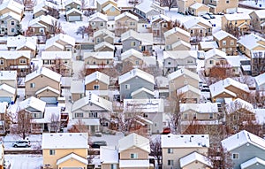Aerial view of a scenic town in the valley with houses against snowy landscape