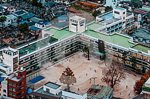 Aerial view school buildings in residential area of Ichikawa district with football field. Tokyo - Japan