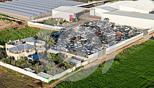 Aerial view on scrap yard with pile of crushed cars