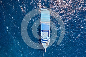 Aerial view of a SCUBA diving liveaboard in a clear, blue tropical ocean