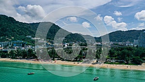 Aerial view of sea front hotels and apartments and tourists enjoying the beach in Patong beach, Phuket island, Thailand.