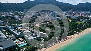 Aerial view of sea front hotels and apartments and tourists enjoying the beach in Patong beach, Phuket island, Thailand.