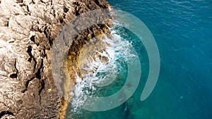 Aerial view of sea hitting the rocks on Porto Katsiki beach. Tropical turquoise sea in summer season on Lefkada island