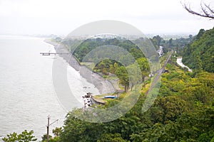 Aerial view of the sea and the railway on a cloudy day