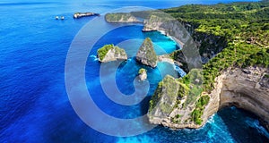 Aerial view at sea and rocks. Azure water background from top view. Panoramic seascape. Kelingking beach, Nusa Penida, Bali, Indon