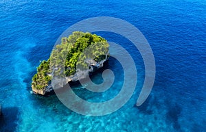 Aerial view at sea and rocks. Blue water background from top view. Summer seascape from air. Atuh beach, Nusa Penida, Bali, Indone